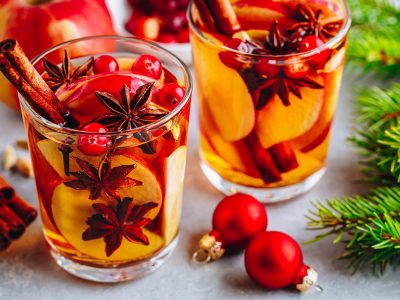 Apple cider mulled wine hot toddy or christmas punch in glass with fruits and spices